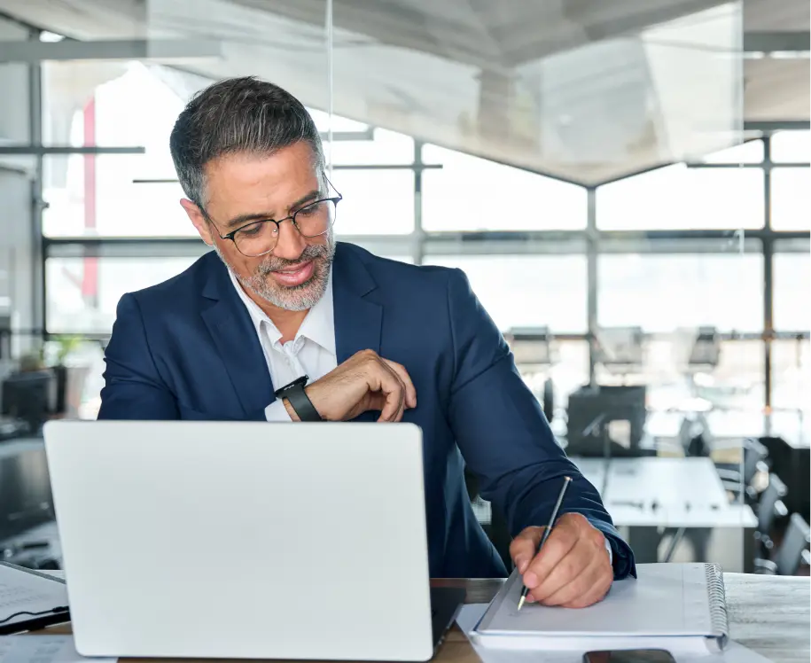 Man writing notes while on a meeting