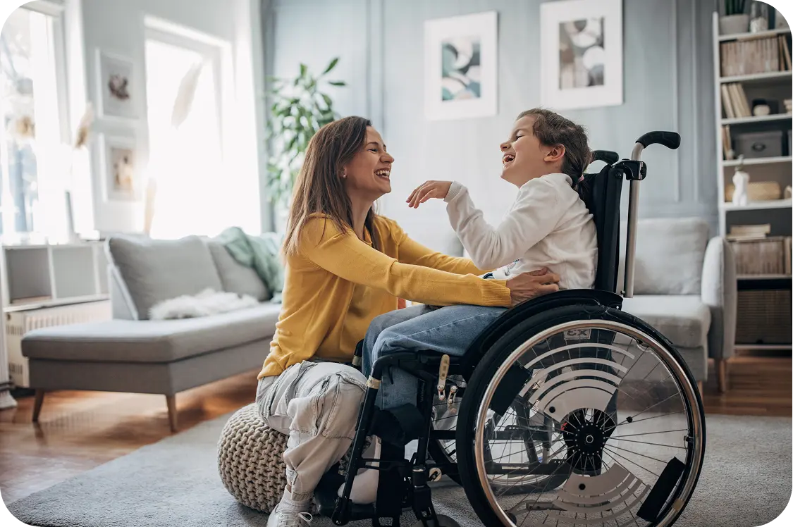 Woman helping child in wheelchair